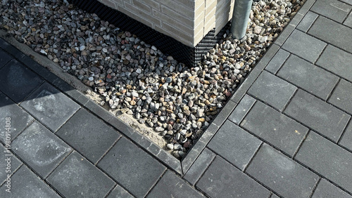 Cuadro en lienzo Close-up view of a corner of a paved patio featuring gray interlocking stones an