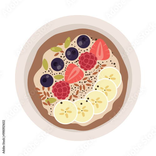 Overhead view of a healthy breakfast bowl filled with oatmeal, sliced bananas, fresh berries, and seeds, presented in a flat lay style with a vibrant and natural feel against a white