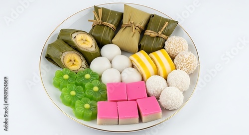 Assorted traditional Asian sweet desserts on white plate with gold rim