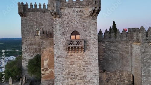 Aerial 4K view of the medieval Almodovar Castle in Cordoba, Spain at sunset. Golden hour light over the ancient fortress with scenic landscape.