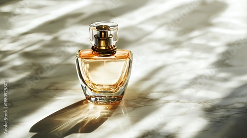 Glass perfume bottle on marble surface with sunlight shadows no people