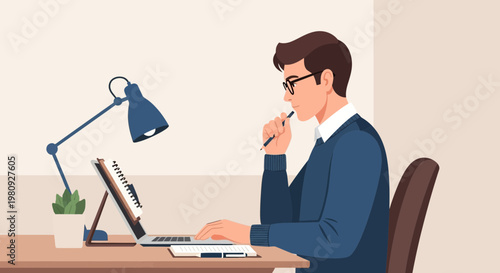 Focused man working on laptop at desk with lamp and plant, modern office setup