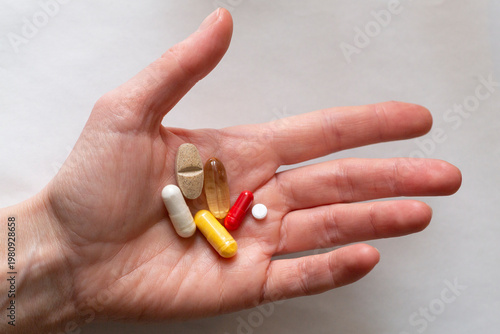 Pills in hand on a white background