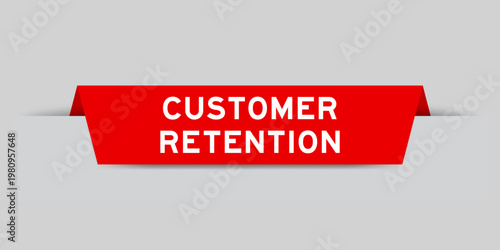 Red color inserted label with word customer retention on gray background