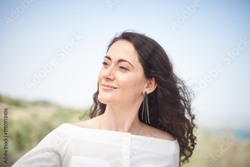 Portrait of a young beautiful brunette woman against the backdrop of the nature of northern Israel