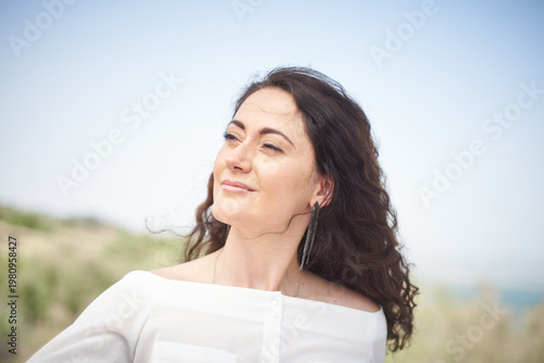 Portrait of a young beautiful brunette woman against the backdrop of the nature of northern Israel