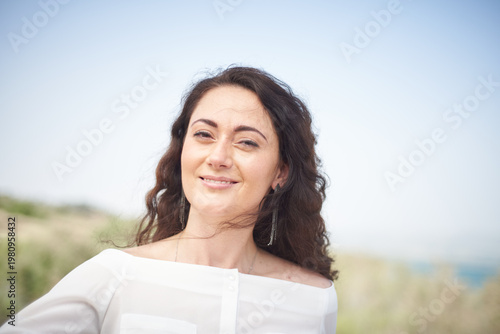 Portrait of a young beautiful brunette woman against the backdrop of the nature of northern Israel