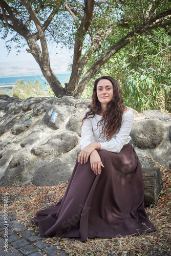 Portrait of a young beautiful brunette woman against the backdrop of the nature of northern Israel