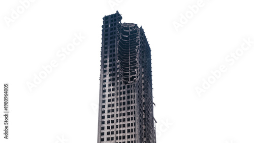 Isolated burnt-out and destroyed skyscraper with exposed concrete structure of a tall building.