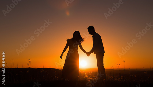 Silhouetted couple holding hands at sunset in a field, with warm orange skies creating a romantic and serene atmosphere.