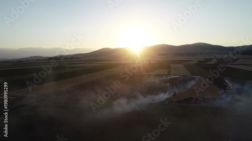 Aerial Drone View of Active Fire Line from Stubble Burning Spreading Across Farmland at Sunset