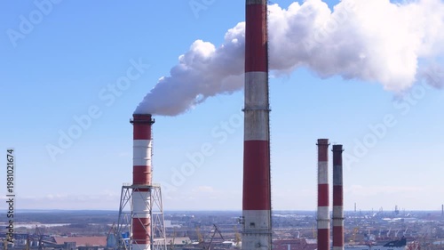Industrial power plant smoking chimneys causing air pollution during energy production and carbon emissions