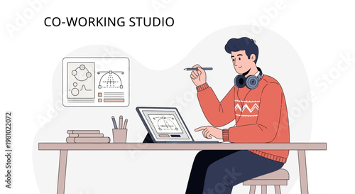 Young man working in a co-working studio with a laptop and stylus