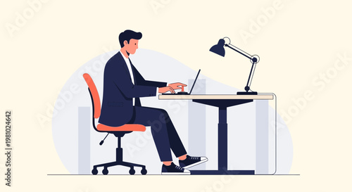 Businessman working on laptop at desk with adjustable height and desk lamp