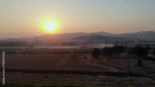 Aerial Drone Footage of Field Stubble Fire Spreading Across Farmland at Sunset