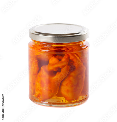 Canned crab claws in a glass jar isolated on white background. Marinated crayfish or crab pincers in oil.