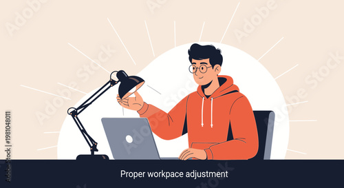 Young man adjusting desk lamp for proper workspace lighting, working on laptop