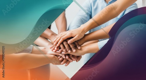 A diverse group of people in casual clothing stack hands together in unity inside a bright office space.