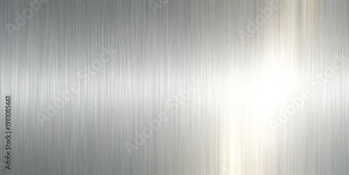 A polished silver stainless steel plate features a brushed metal texture with a shiny industrial gray pattern. A sleek brushed metal texture provides a polished silver and gray metallic background.