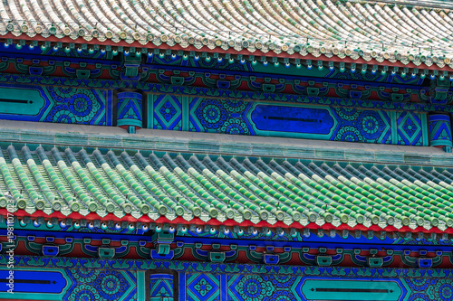 An extreme close-up highlights the stunningly detailed, multi-layered eaves and colorful glazed tiles of the traditional architecture at the Temple of Heaven in Beijing.