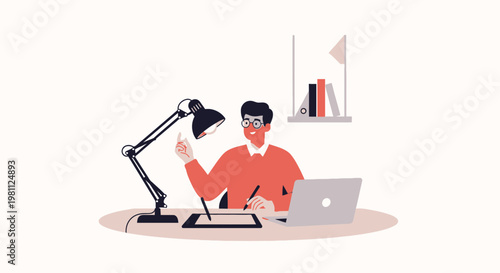Graphic designer working on tablet with laptop and lamp at desk