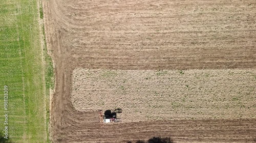 Aerial Drone View of Tractor Plowing Agricultural Field with Patterned Farmland