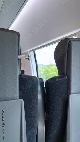 Vertical 4K video. Carriage empty interior of modern high speed passenger train with seats, chairs, window. Concept of transportation, tourism, railway station, travel, trip, departure, arrival