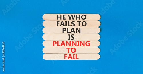 Planning to fail symbol. Concept words He who fails to plan is planning to fail on beautiful wooden sticks. Beautiful blue paper background. Business planning to fail concept. Copy space.
