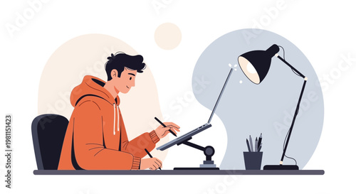 Young graphic designer working on a digital tablet at a desk with a laptop and lamp