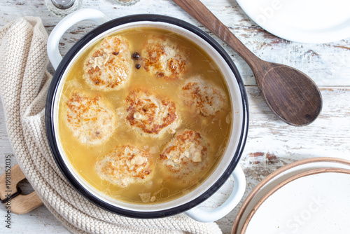 Homemade kale cutlets with sauce in a saucepan, top view