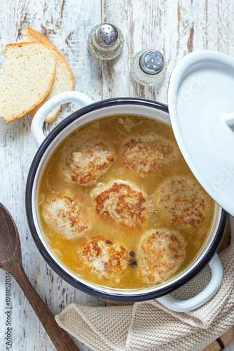 Homemade kale cutlets with sauce in a saucepan, top view