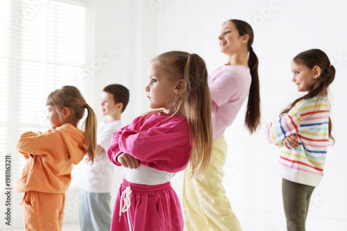 Fotografía Professional dance teacher training children in studio, selective focus