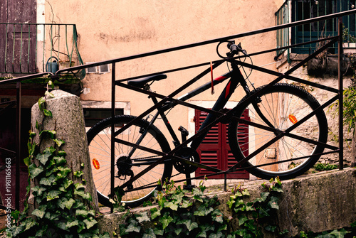 bicycle leaning at railing in front of an old building in Annecy France