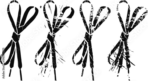 Four bundles of black twine tied in heart shaped loops on white background