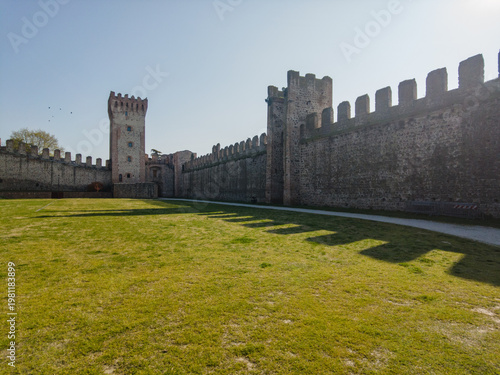 Exploring Este Castle in Padua, Italy, with its historic walls and towers under bright sunlight during the day