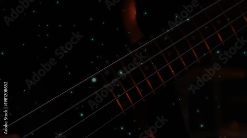 4-string bass neck tilting, teal specks drifting, hand entering and plucking strings, showing tone