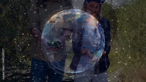 Rotating digital globe revealing faces and hands while farming pair presenting handfuls of olives