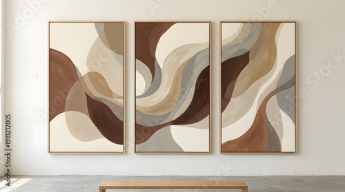 Set of three abstract art prints featuring flowing organic shapes in a neutral color palette of beige, brown, and grey, framed in light wood