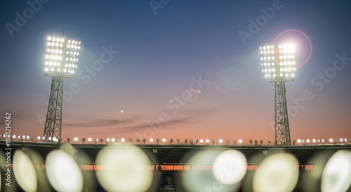 Bright stadium floodlights illuminating the evening sky during a professional sports match event
