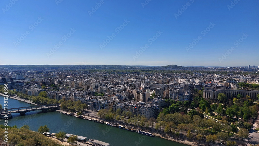 Fototapeta premium The city of Paris. From the top of the Eiffel Tower. The Seine River.