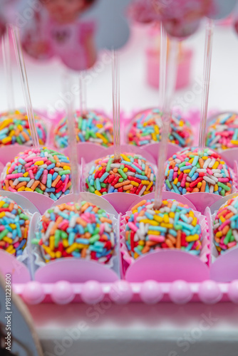 Colorful Chocolate Cake Pops with Sprinkles Close Up Birthday Party Sweets Dessert Table Selective Focus Soft Background