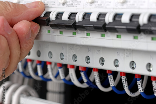 The arm turns on the residual current circuit breaker in the electrical switchboard. 