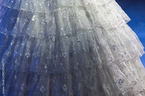 Tableau sur toile White tiered lace dress with floral embroidery close-up