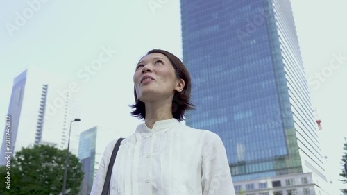 Japanese Woman Looking Up and Smiling Outdoors, Fulfilled and Relaxed, Mental Wellness, Urban