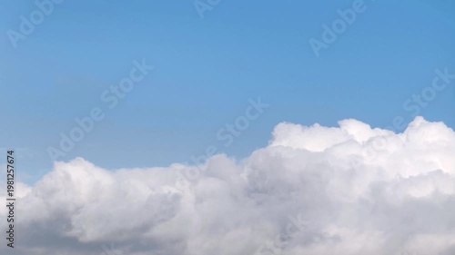 Dark cumulonimbus clouds growing in the blue sky