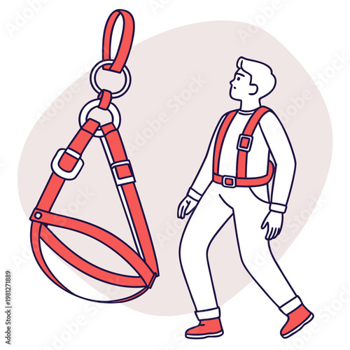 Worker wearing a safety harness for fall protection and industrial work security standing next to suspended harness.