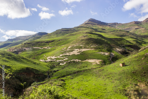 A small, abandoned hut in the Drakensberg Mountains in the Golden Gate Highlands National Park, South Africa, with the grasslands green after the summer rain