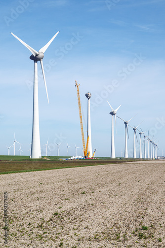 Wind turbine installation in polder landscape Netherlands