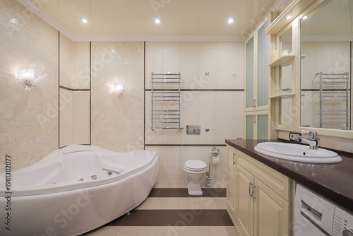 Bathtub and sink with mirror in the bathroom