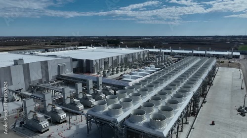 Pan of an Ai datacenter cooling with the building, chillers, cooling tower, and other mechanical equipment to make larger power hungry data centers work. 